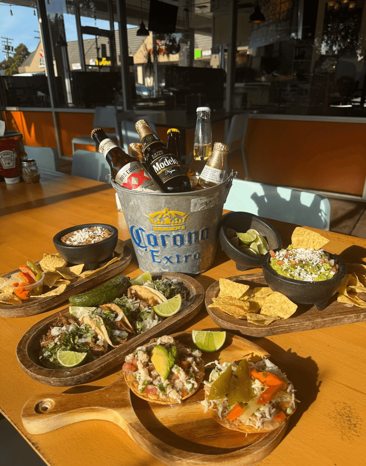 Taco spread with a beer bucket on the patio table at Roberta's Cocina Mexicana, Sacramento